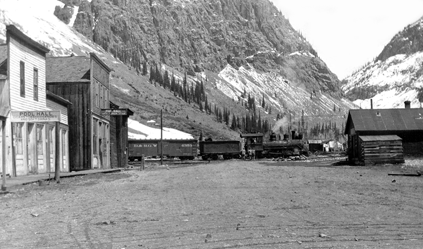 Downtown Eureka's main street in the 1920s with a Silverton Northern train that has just crossed the Animas River headed to Silverton.