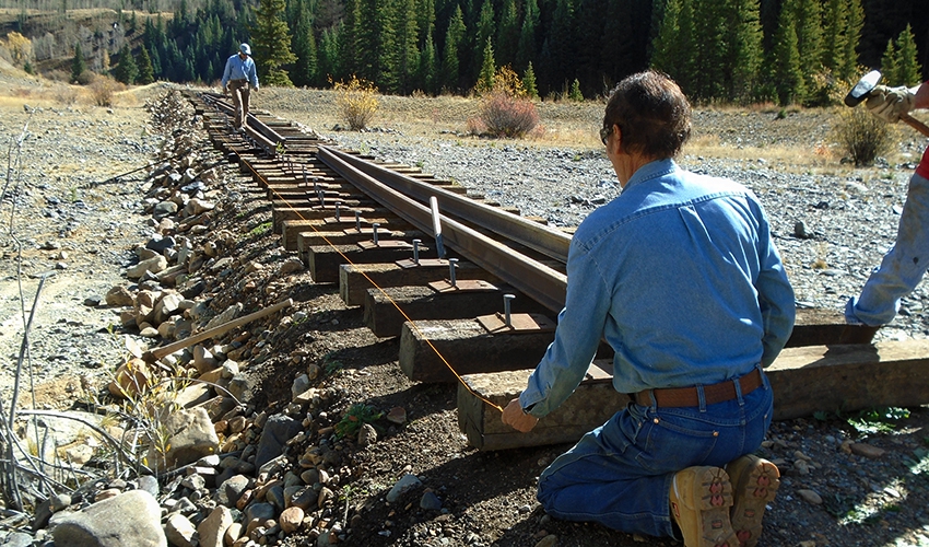 Mike Geryak works with Loren Lew to align ties.