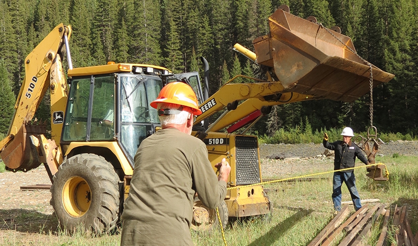 Mac Brewer and Mike Geryak stacking rail that was trucked over from Ridgway in August of 2016.